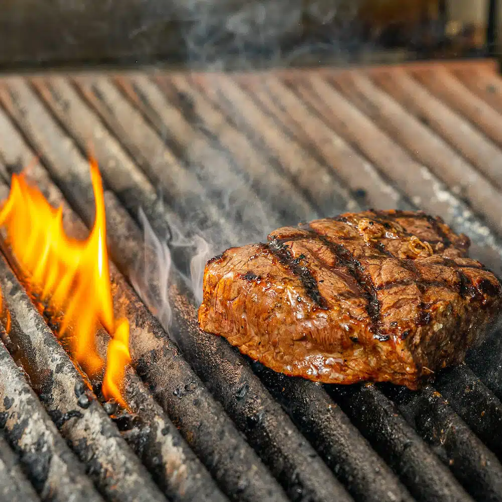 Steak cooking on a grill