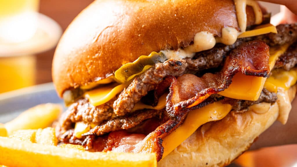 Triple Double Smash burger on a plate with chips